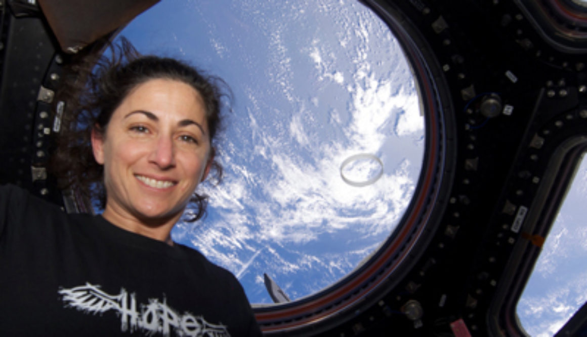 nicole stott astronaut at international space station looking at earth